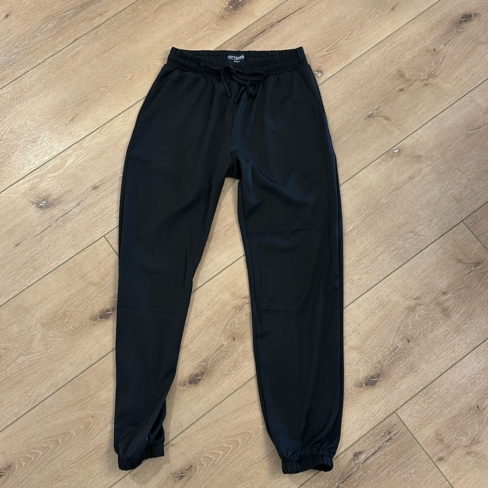 Black silk look, kittenish, joggers, elastic, and tie waist, no pockets.